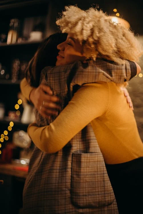 two girls hugging and expressing gratitude