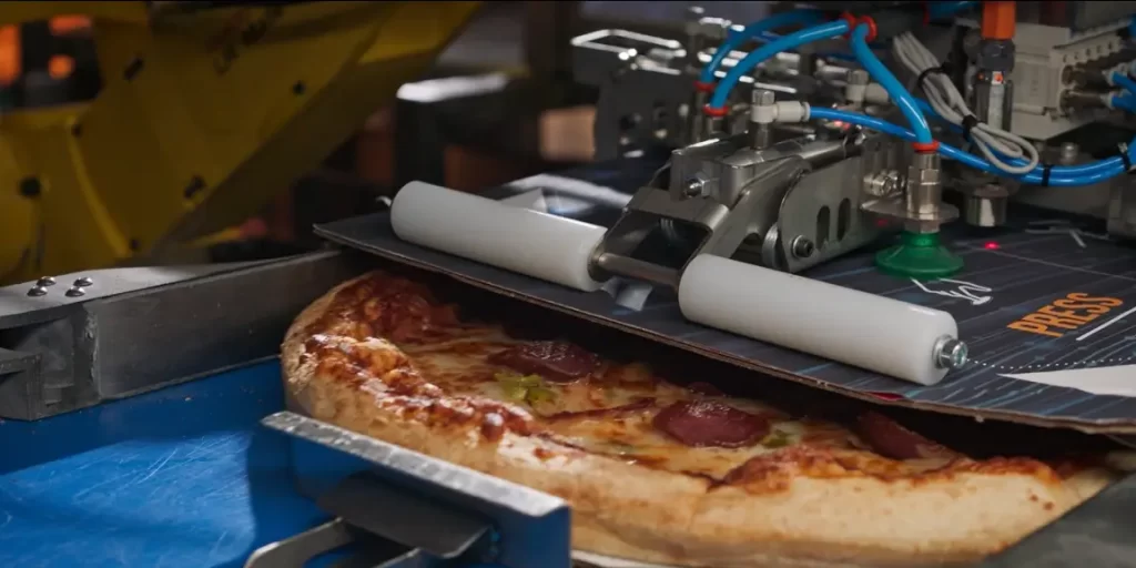 robot boxing up a pizza